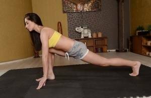 Cute brunette babe Aruna Aghora doing yoga in shorts and bare feet on galpictures.com