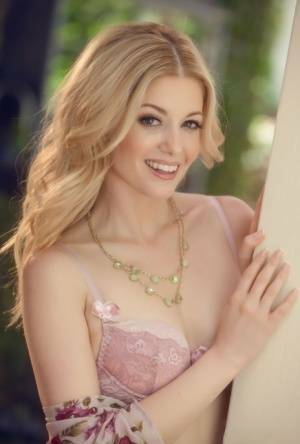 Beautiful blonde Charlotte Stokely uncovers tiny tits before petting her pussy on galpictures.com