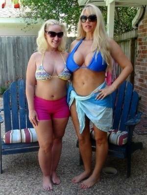 Blonde chicks Karen Fisher and Dee Siren loose their big tits from bikini tops on galpictures.com
