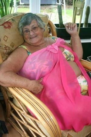 Horny old granny in glasses disrobes to reveal huge saggy tits & big BBW ass on galpictures.com