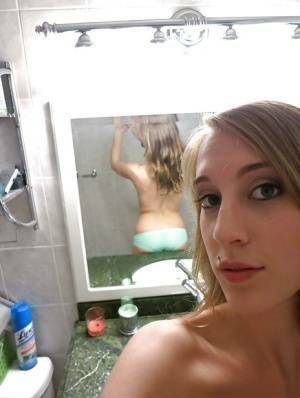 Smiley amateur Cadence Lux stripping and picturing herself in the bath on galpictures.com