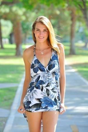 Pretty fresh faced girl hikes her sexy dress to show naked ass on the street on galpictures.com