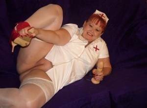 Mature redheaded nurse Valgasmic Exposed exposes herself during dildo play on galpictures.com