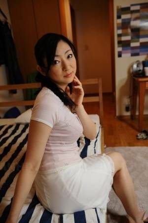 Slender mature Japanese woman Emiko Koike bends over to pose in white dress - Japan on galpictures.com