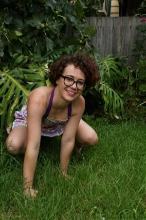Geeky girl Rosie wears her glasses for her nude debut on the back lawn on galpictures.com