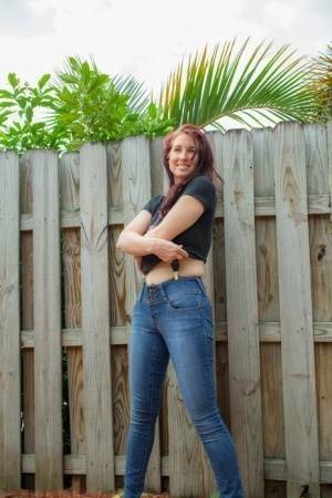 Hot redhead Andy Adams loses her t-shirt & jeans in the yard to pose naked on galpictures.com