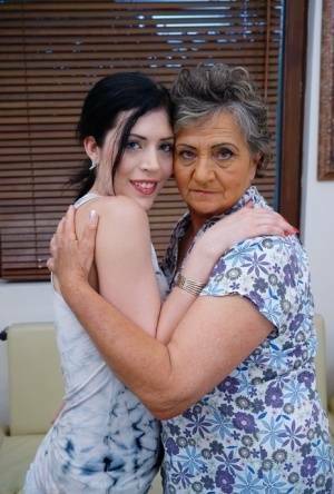 Lesbian granny worshipping sexy teen's attractive body and holes on galpictures.com