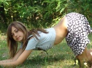 Shapely young teen in tiny t-shirt and short skirt posing outdoors on galpictures.com