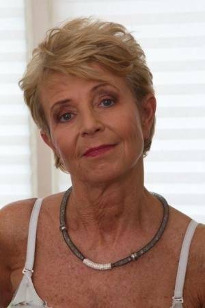 Blonde granny sports short hair while masturbating with a vibrator on galpictures.com