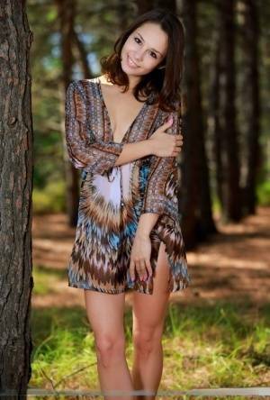 Sweet teen with an ass to die for disrobes for great nude poses in a forest on galpictures.com