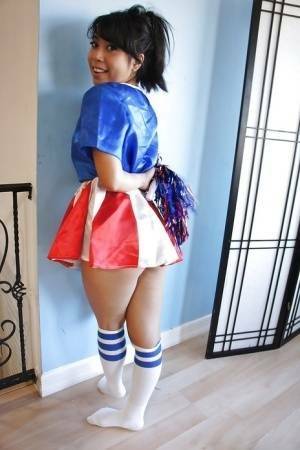 Tiny Asian cheerleader May Lee posing in cute uniform and socks on galpictures.com