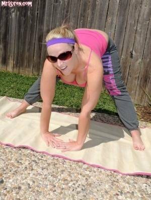 Blonde chick Dee Siren frees her huge ass from yoga pants outdoors on yoga mat on galpictures.com