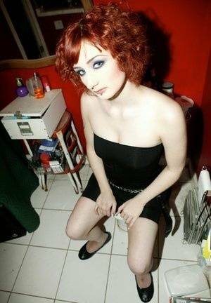 Pale redhead Violet Monroe gets naked in flat shoes while in a bathroom on galpictures.com
