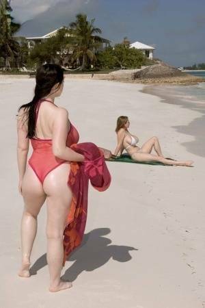 Plump female Christy Mark and her big boobed friend have lesbian sex on beach on galpictures.com