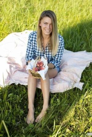 Nice teen Paulina gets completely naked on a blanket in a field on galpictures.com