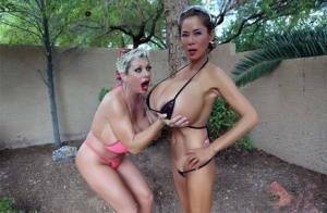 Big titted older women Claudia Marie and Minka kiss outdoors in skimpy bikinis on galpictures.com