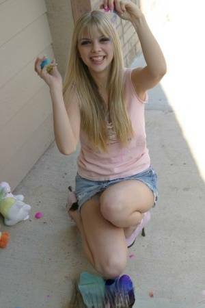 Sweet blonde teen Jana Jordan flashes upskirt panties while eating chocolate - Jordan on galpictures.com