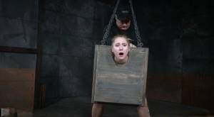 Blonde girl Odette Delacroix is made to suck a black cock with head in stocks on galpictures.com