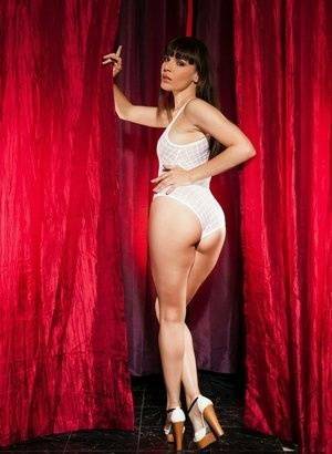 Leggy brunette Dana Dearmond sets her boobs free from bodysuit in heels on galpictures.com