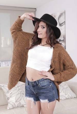 Latina babe Penelope Cum flaunting nice ass in denim shorts and cowgirl hat on galpictures.com
