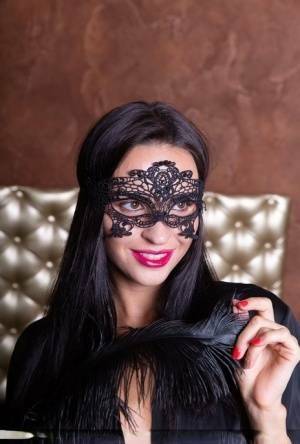 Sexy brunette Leyla Lee removes a mask and robes to pose nude with a feather on galpictures.com