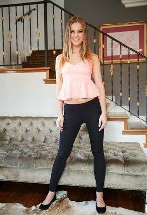 Slim white girl Jillian Janson wears a nice smile while removing spandex pants on galpictures.com