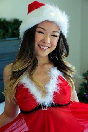 Cute Asian teen Lulu Chu wears Xmas lingerie during sex on a bed on galpictures.com