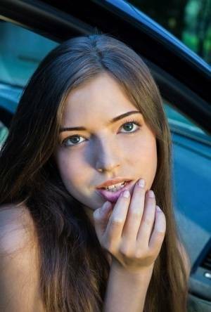 Beautiful teen girl models in the nude on passenger seat of car with door open on www.galpictures.com