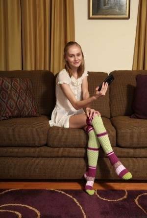 Adorable teen Alicia Williams takes a selfie before getting naked in OTK socks on galpictures.com