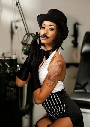 Ebony pornstar Skin Diamond strutting in vintage hat and long gloves on galpictures.com
