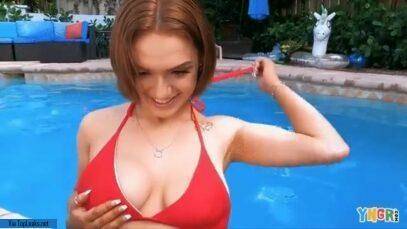Gracie Gates coyly undoes her top in the pool on galpictures.com
