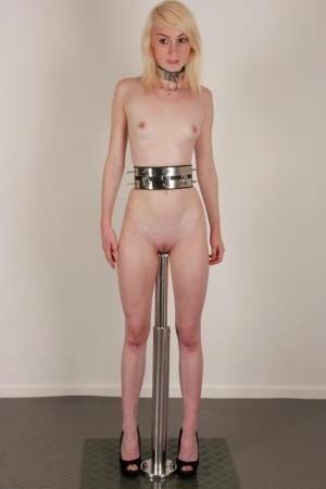 Skinny blonde teen Noa sports a collar while impaled on a dildo post on www.galpictures.com