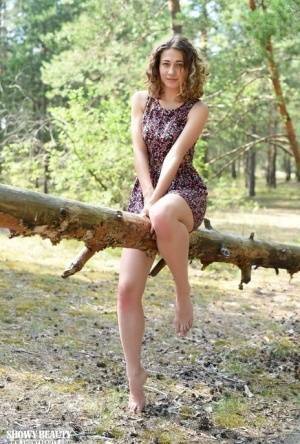 Nice young girl Ari gets completely naked while in a forested area on galpictures.com